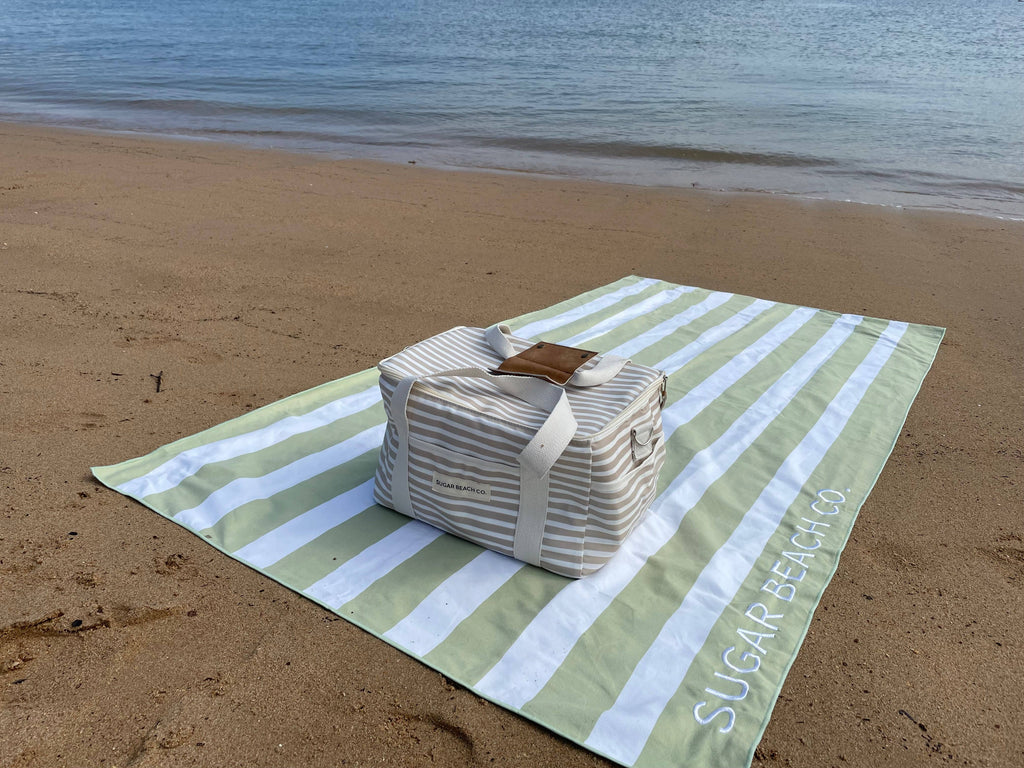 Beach towel with Cooler bag on the beach 