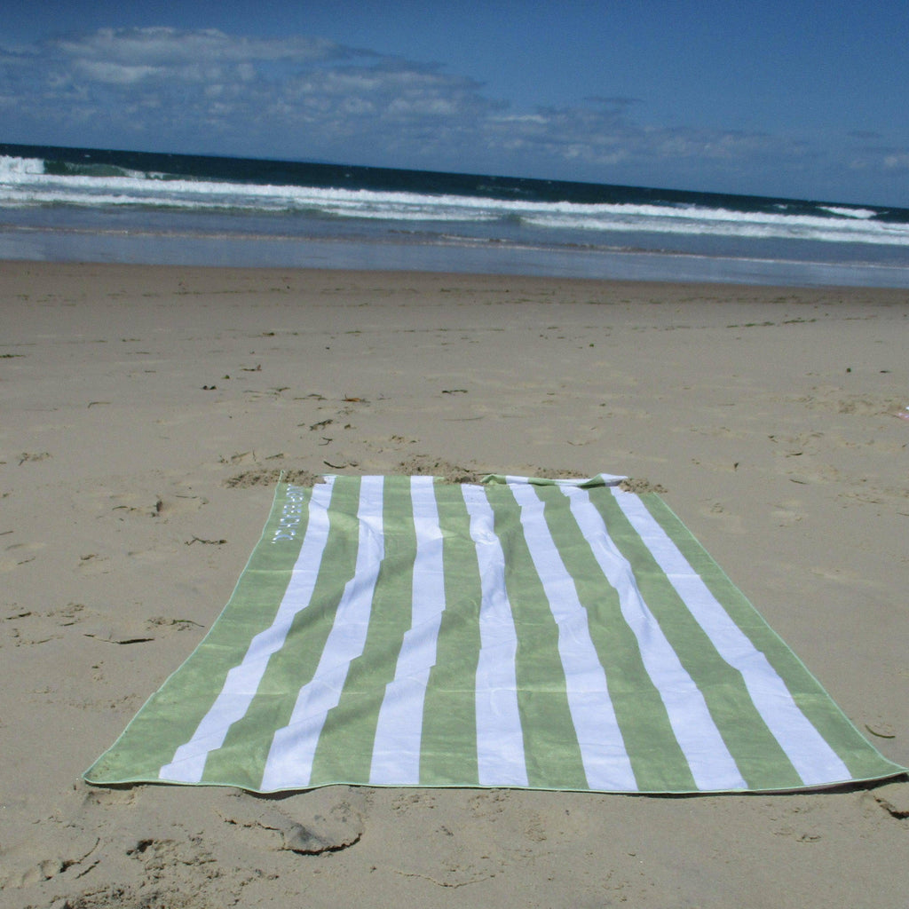 Sand resistant beach towel lying on the beach.