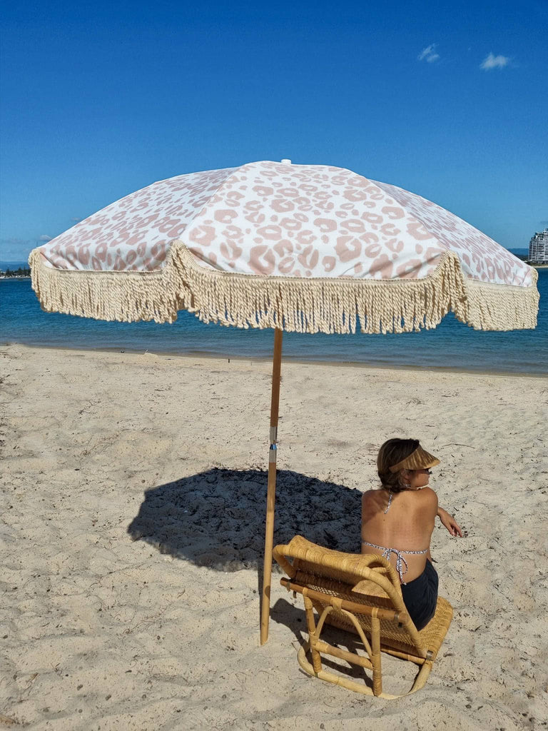 Sitting under a wild side umbrella on the beach